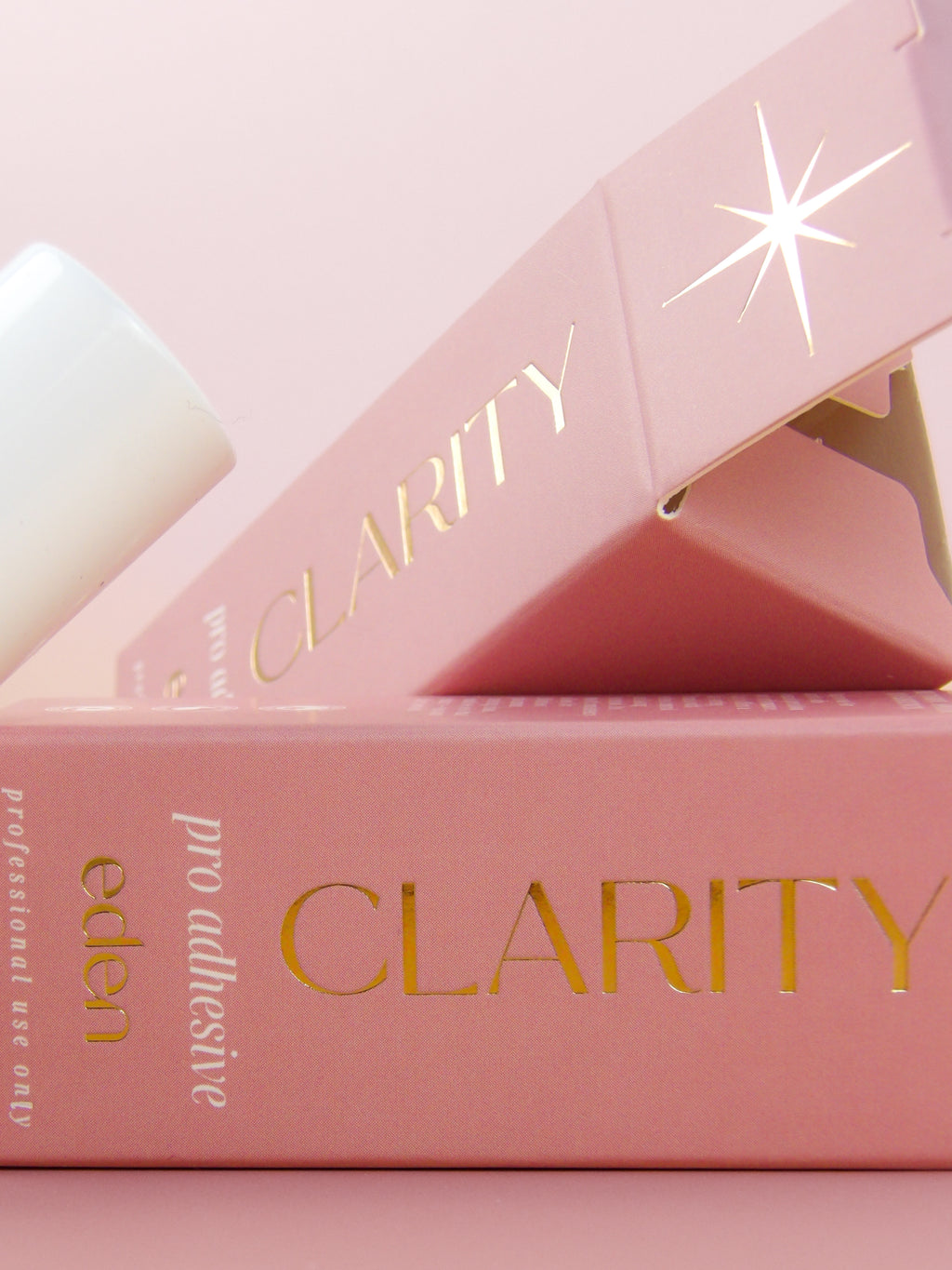 Pink packaging with 'Clarity' branding on a light pink background