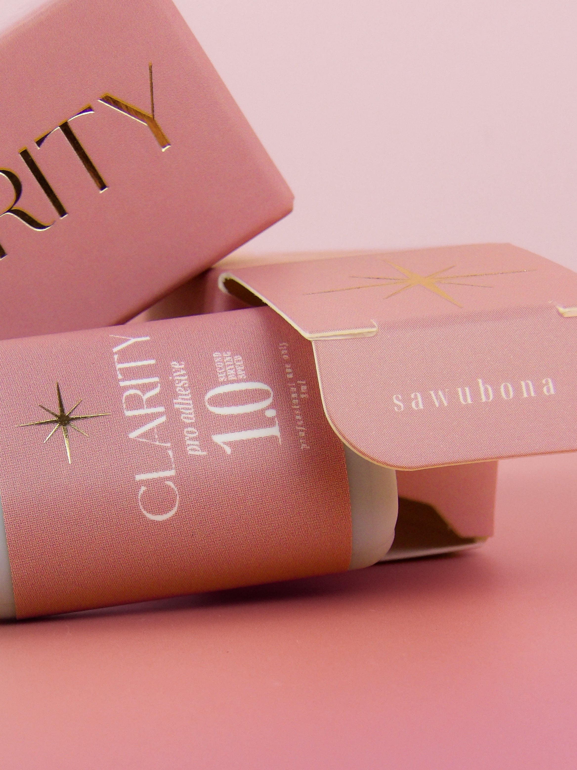 lash packaging with 'Clarity' and 'sawubona' text on a pink background