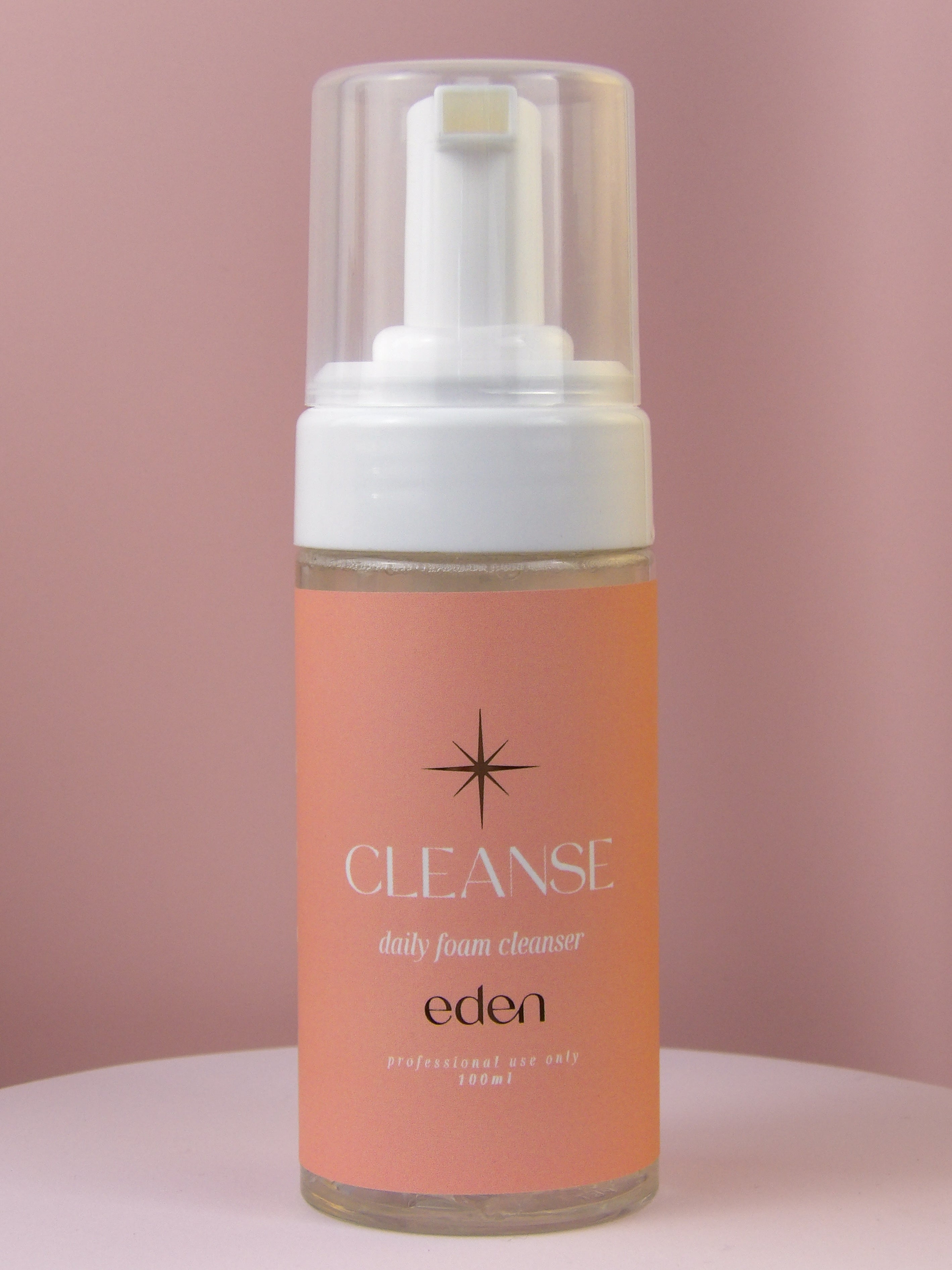 Foam cleanser bottle labeled 'Cleanse' by 'Eden' on a pink background