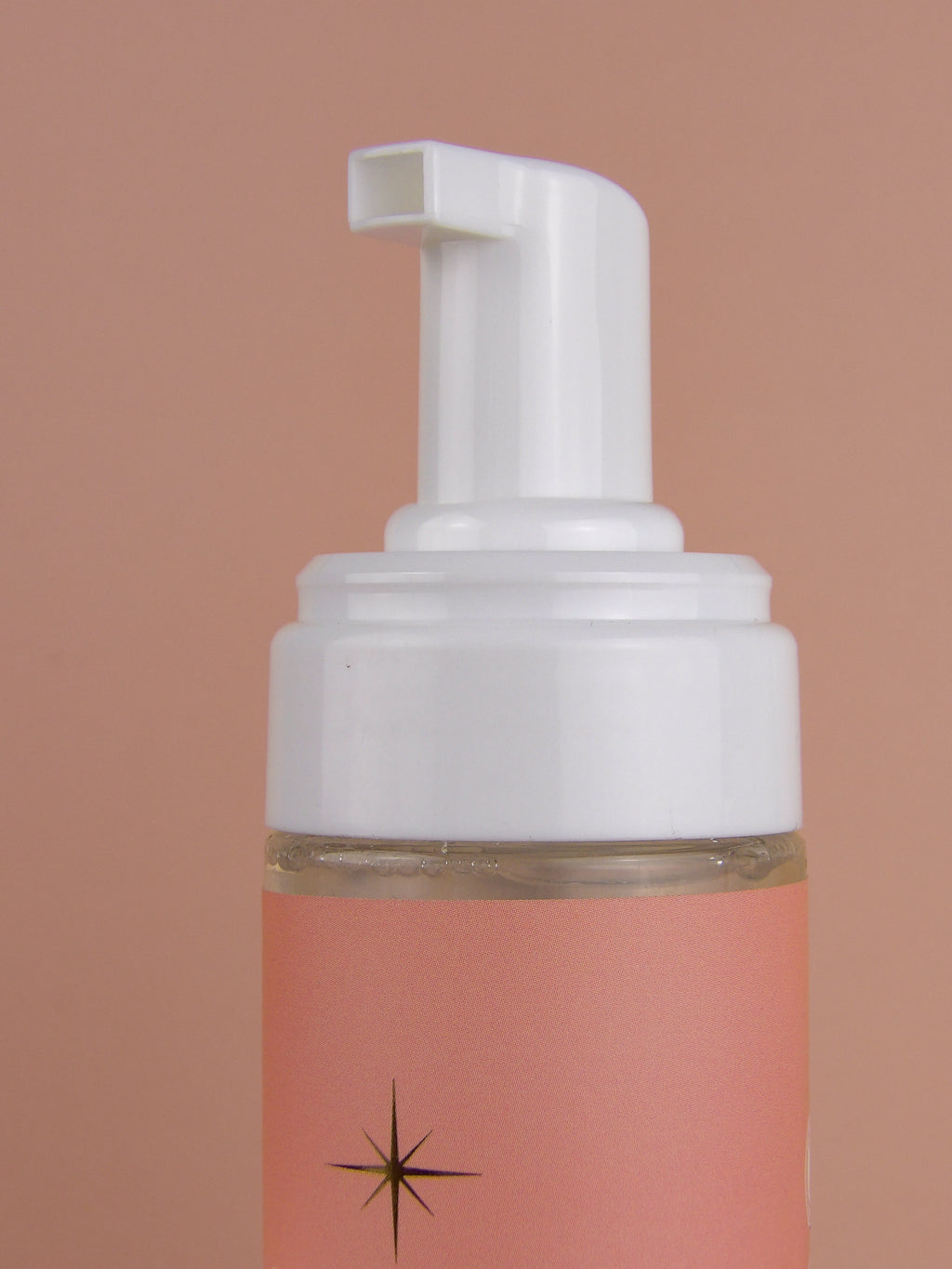 Foam pump bottle with a starburst design on a gradient background