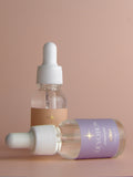 Two bottles of Devotion skincare product on a beige background