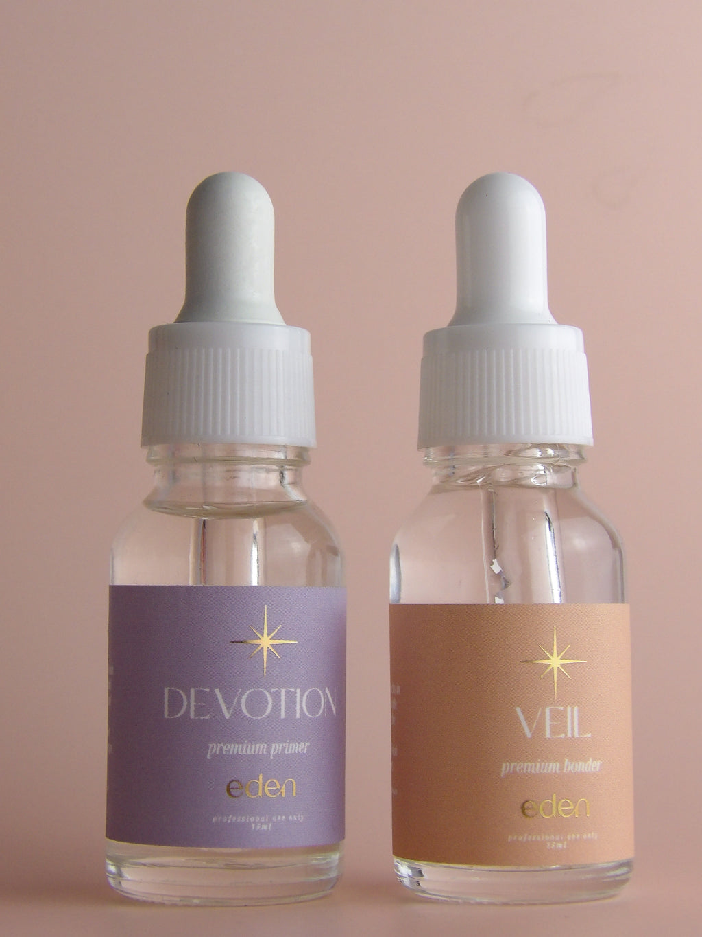 Two bottles of 'Devotion' and 'Veil' with droppers on a beige background