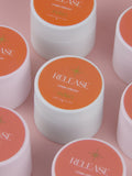 Multiple jars of 'Release' cream remover on a pink background