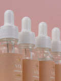 Bottles of Veil premium e-liquid on a pink background